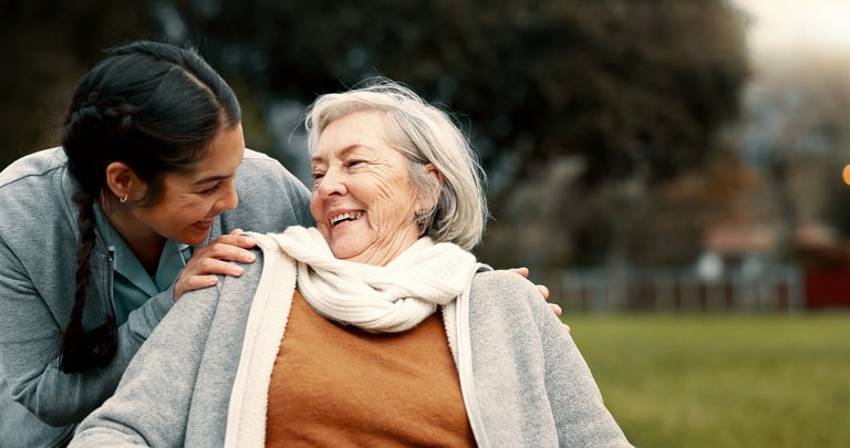 Caregiver and senior in garden setting