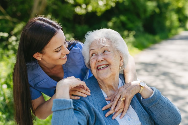 Caregiver and resident enjoying outdoor walk