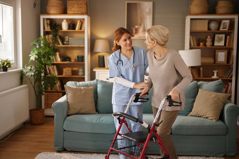 Nurse assisting elderly woman with walker