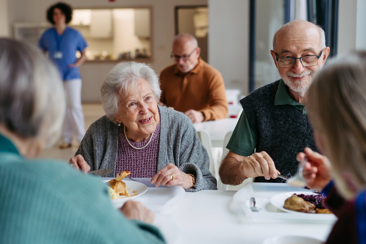 Care team gathered around table with residents