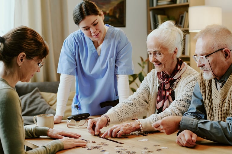 Residents enjoying puzzle activity with caregiver